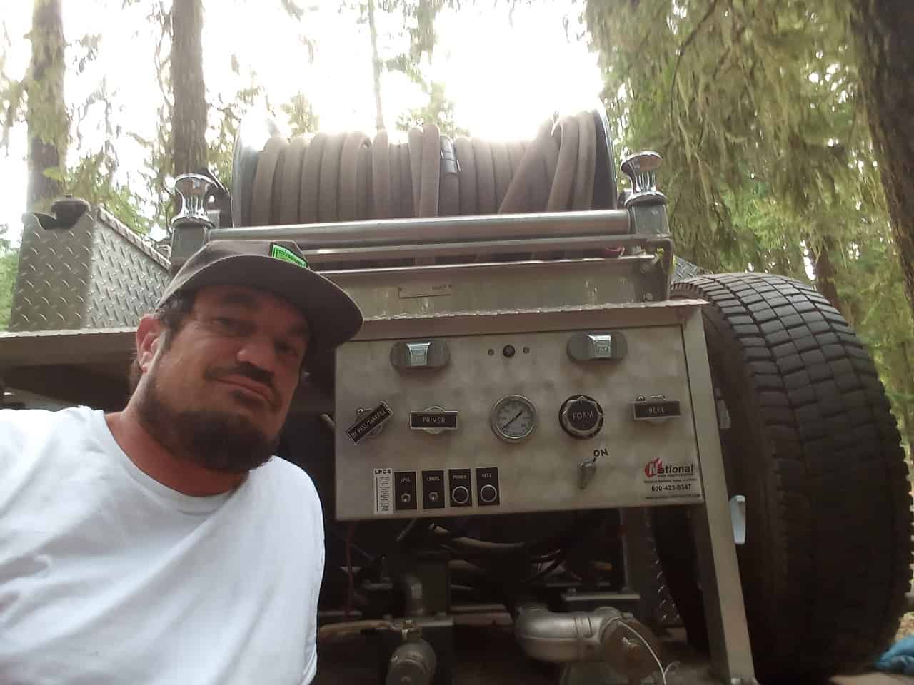 The founder standing in front of the automated wildfire water truck