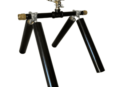 A portable wildfire sprinkler system with black legs and brass fittings, designed for automated fire prevention and remote monitoring in Central Oregon.