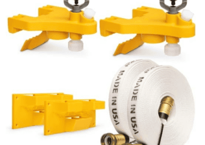Yellow wildfire sprinkler heads with mounting brackets and a coiled hose with fittings, designed for automated fire protection systems.