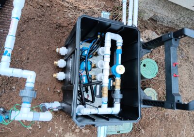 Automatic wildfire sprinkler system with pipes and controllers installed outdoors in Bend, Oregon, by Wildfire Watchdog, designed for remote monitoring and protection against wildfires.