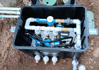 Automatic wildfire sprinkler system with pipes and controllers installed outdoors in Bend, Oregon, by Wildfire Watchdog, designed for remote monitoring and protection against wildfires.