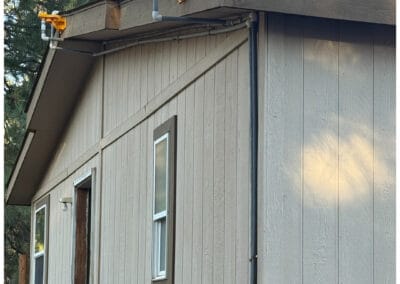 Rainwater drainage pipes with sprinkler heads installed on the roof, part of Wildfire Watchdog’s automated wildfire sprinkler system in Central Oregon.