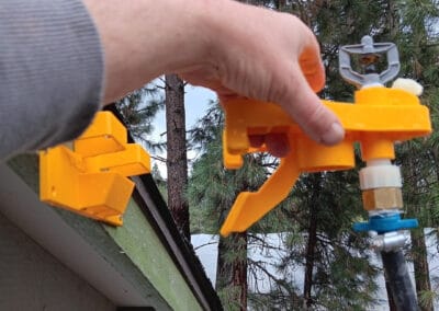 Sprinkler system installation on a roof in Central Oregon with Wildfire Watchdog devices for wildfire prevention.