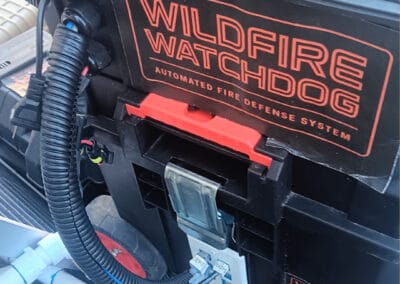 WILDFIRE WATCHDOG automated wildfire detection and sprinkler system installed on a roof, featuring ESP32/ESP8266 controllers for reliable remote monitoring.